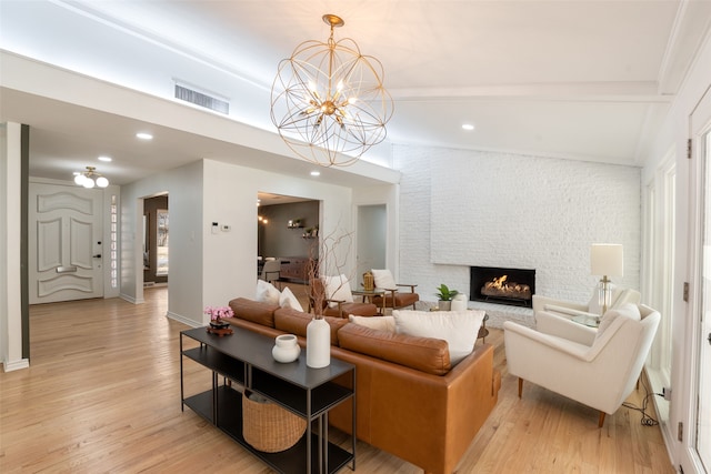 living room featuring recessed lighting, a fireplace, visible vents, and light wood finished floors