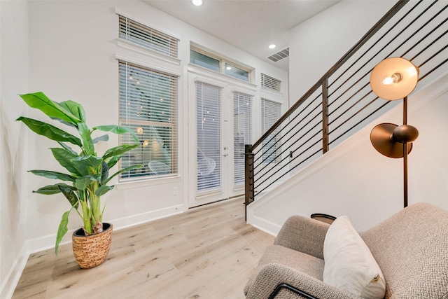 foyer entrance featuring visible vents, baseboards, stairway, recessed lighting, and wood finished floors