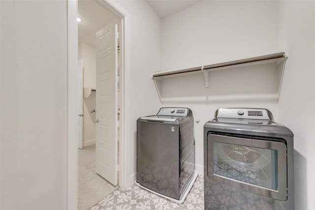 laundry room with washer and dryer, baseboards, and laundry area