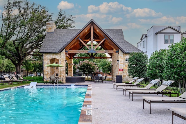 pool featuring a gazebo, fence, and a patio