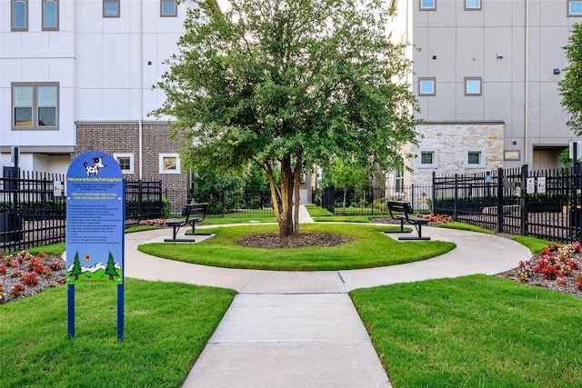 view of home's community featuring a yard and fence