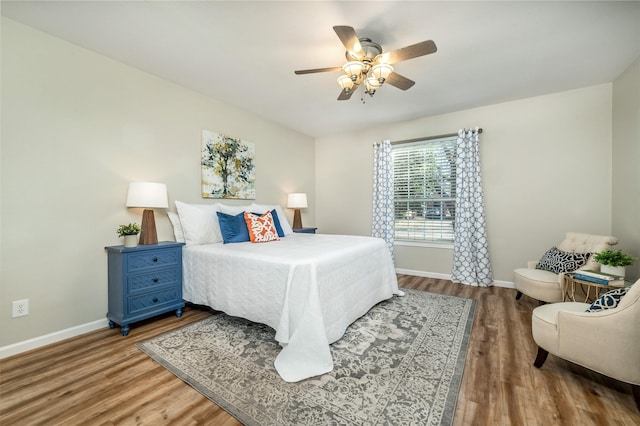 bedroom featuring a ceiling fan, wood finished floors, and baseboards