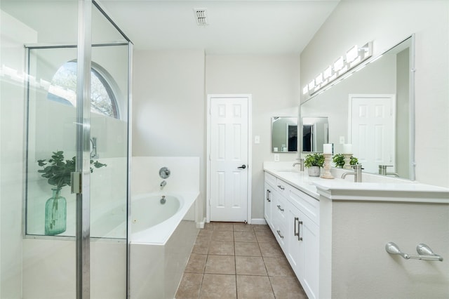 full bathroom with a garden tub, double vanity, a stall shower, tile patterned floors, and a sink