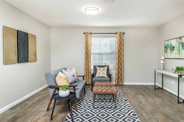 sitting room featuring visible vents, baseboards, and wood finished floors