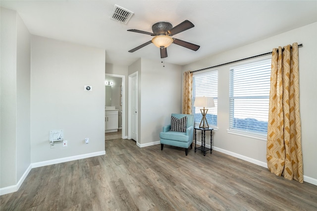 unfurnished room featuring visible vents, ceiling fan, baseboards, and wood finished floors