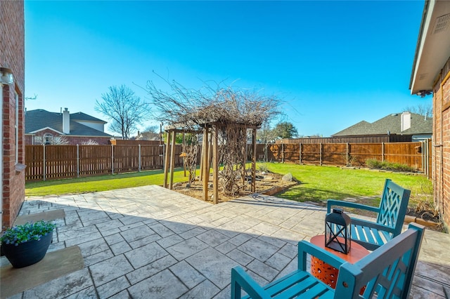 view of patio featuring a vegetable garden and a fenced backyard