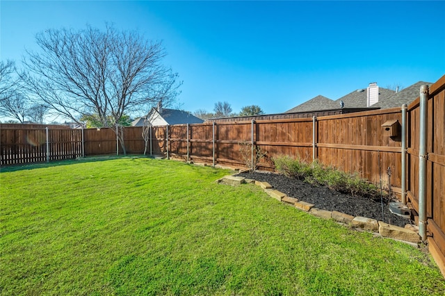 view of yard with a fenced backyard