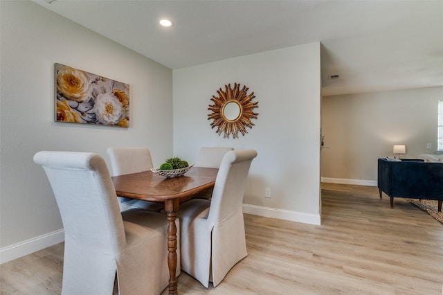 dining space with light wood finished floors, recessed lighting, and baseboards