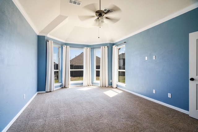 spare room with visible vents, crown molding, baseboards, ceiling fan, and carpet floors