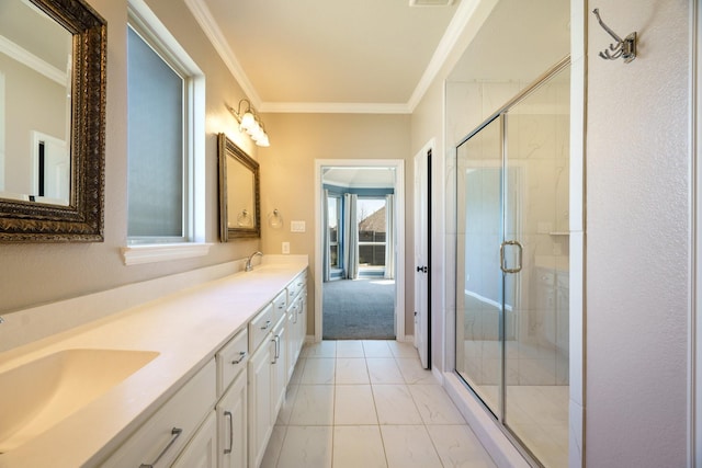 full bathroom with crown molding, a stall shower, and a sink