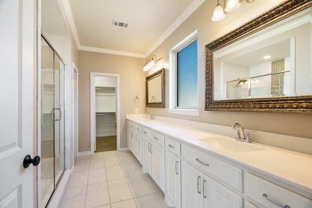 bathroom with visible vents, a stall shower, crown molding, and a sink