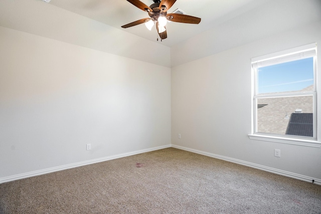 spare room with carpet flooring, baseboards, and a ceiling fan