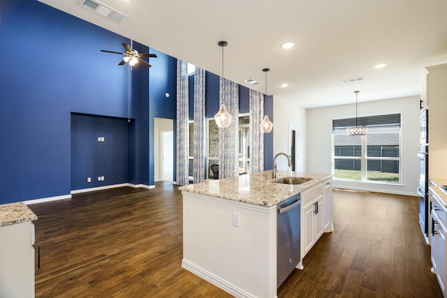 kitchen with visible vents, dark wood-type flooring, a sink, white cabinetry, and dishwasher