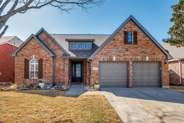 view of front facade featuring concrete driveway, a garage, brick siding, and a front yard