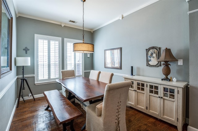 dining area featuring baseboards, ornamental molding, and dark wood-style flooring