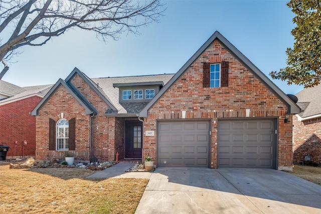 traditional-style house featuring an attached garage, brick siding, driveway, and a shingled roof