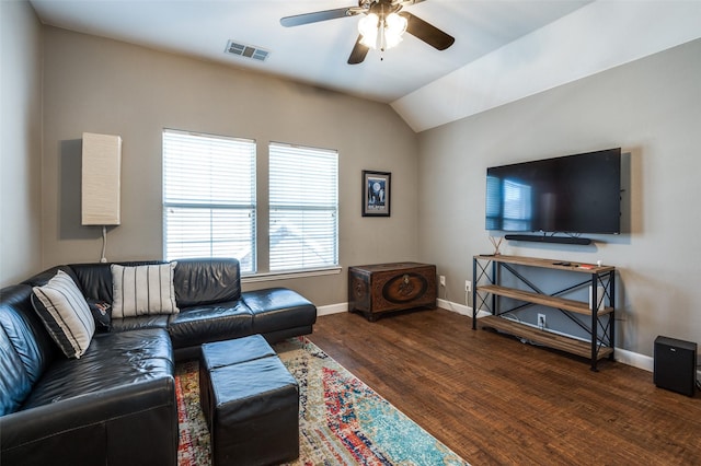 living area with wood finished floors, visible vents, baseboards, ceiling fan, and vaulted ceiling