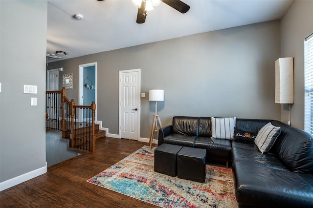 living area featuring ceiling fan, baseboards, and wood finished floors