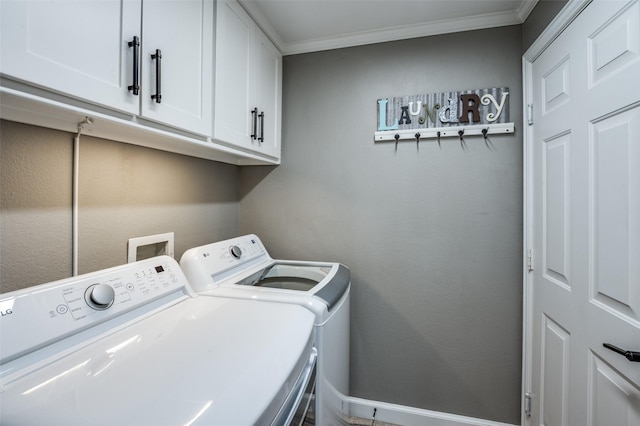 clothes washing area with cabinet space, washing machine and dryer, and crown molding