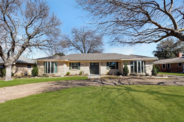 view of front of home with a front yard and brick siding