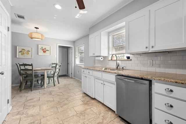 kitchen featuring tasteful backsplash, dishwasher, white cabinetry, and a sink