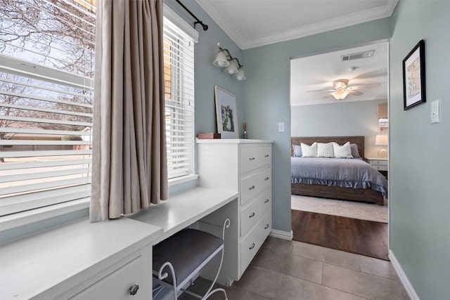 bedroom featuring dark tile patterned flooring, baseboards, visible vents, and ornamental molding