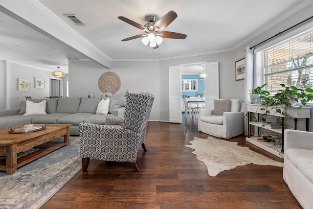 living area featuring a ceiling fan, wood finished floors, visible vents, and ornamental molding