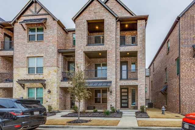 multi unit property featuring brick siding and cooling unit