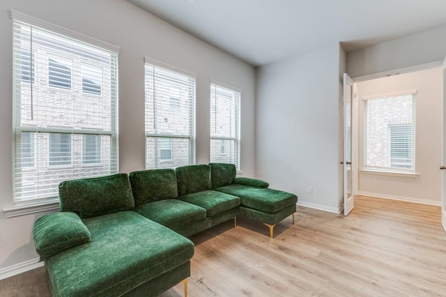 living room with light wood-type flooring and baseboards