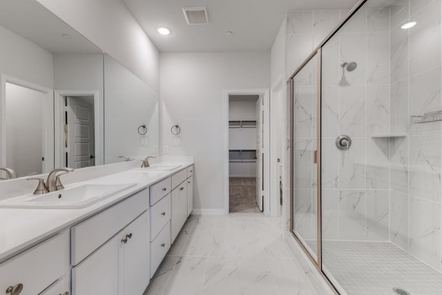 bathroom with visible vents, marble finish floor, a marble finish shower, and a sink