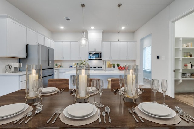 dining space with recessed lighting and visible vents