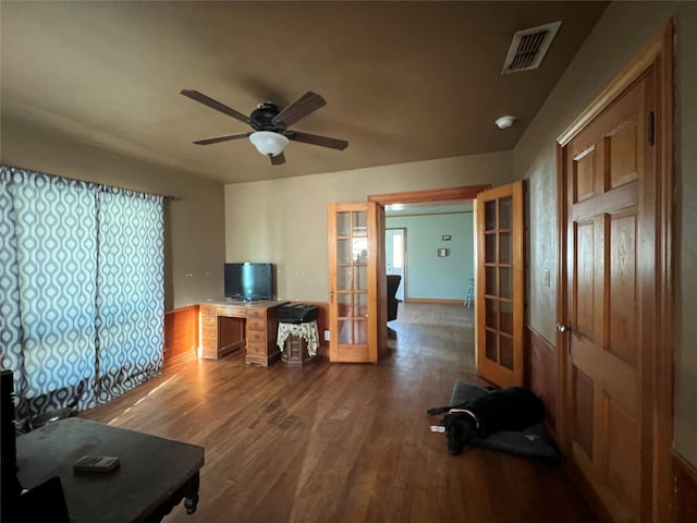 office area featuring wood finished floors, french doors, visible vents, and ceiling fan