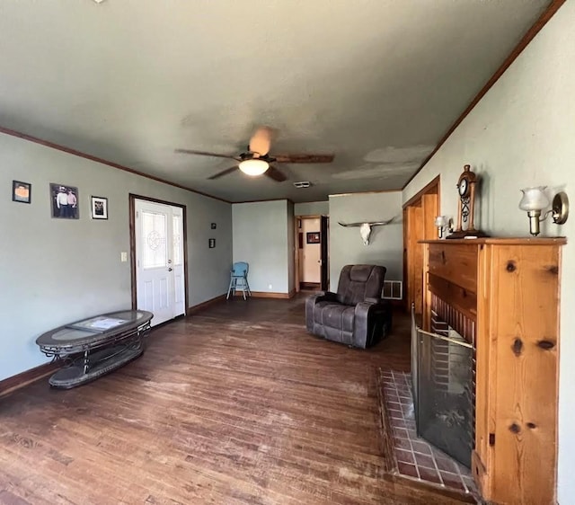 sitting room with a fireplace, crown molding, and wood finished floors