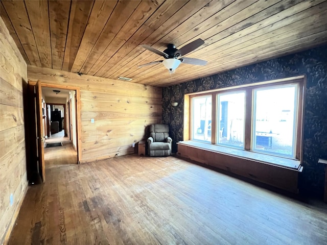 unfurnished room featuring wood ceiling, ceiling fan, and hardwood / wood-style flooring