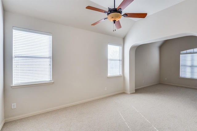 unfurnished room featuring ceiling fan, baseboards, carpet, and vaulted ceiling