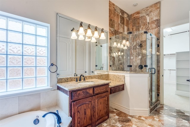 bathroom featuring vanity, a bathing tub, and a stall shower