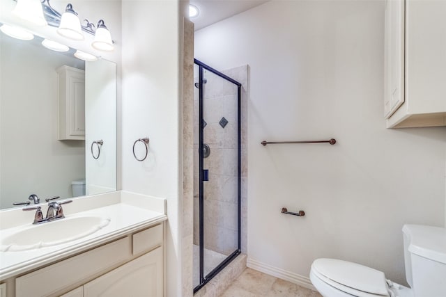 bathroom with vanity, tile patterned floors, toilet, and a stall shower