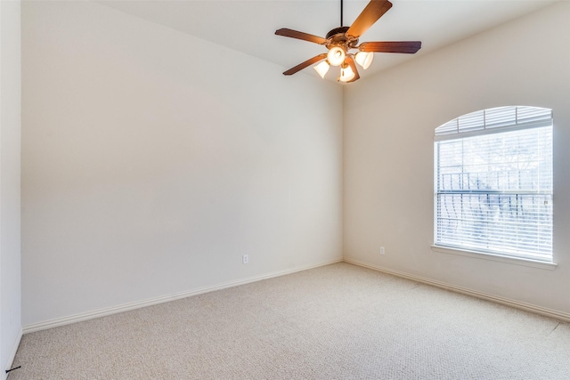 unfurnished room with baseboards, light carpet, and ceiling fan