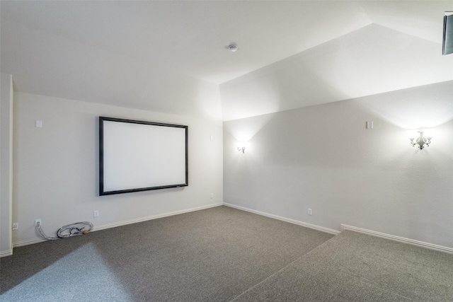 carpeted cinema room with baseboards and lofted ceiling