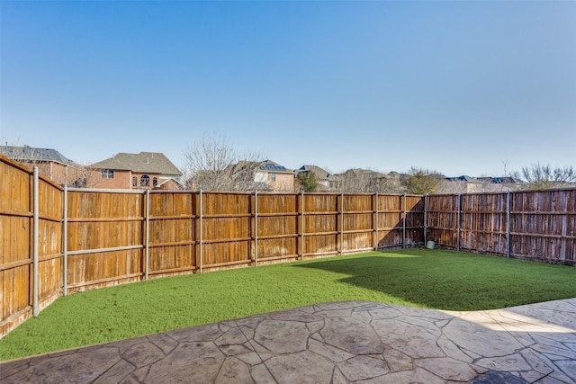 view of yard featuring a patio area and a fenced backyard