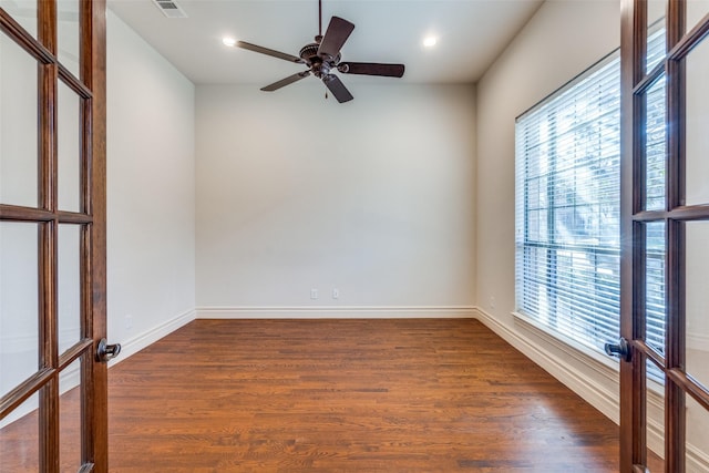 spare room with a ceiling fan, dark wood-style floors, baseboards, recessed lighting, and french doors