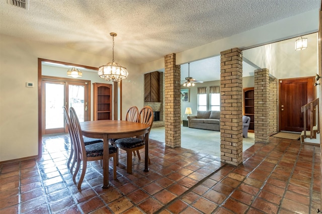 dining area with visible vents, a textured ceiling, a healthy amount of sunlight, and ceiling fan with notable chandelier