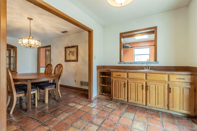 dining space with baseboards, visible vents, a textured ceiling, and an inviting chandelier