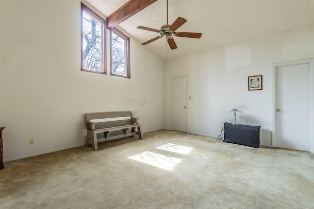 spare room featuring beamed ceiling, carpet flooring, high vaulted ceiling, and ceiling fan