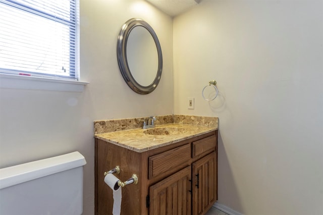 bathroom with toilet and vanity