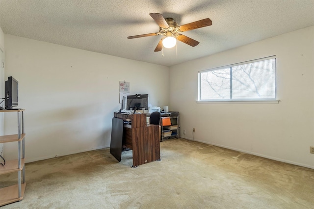 office with a textured ceiling, carpet flooring, and ceiling fan