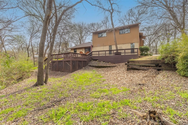 rear view of property featuring a deck