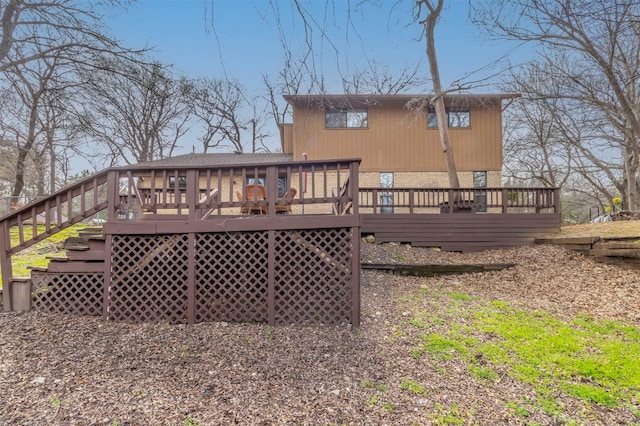 rear view of house with a deck and brick siding