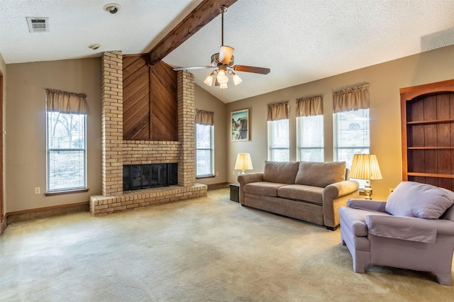 carpeted living area with visible vents, a ceiling fan, a textured ceiling, a brick fireplace, and vaulted ceiling with beams