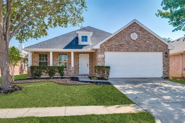 view of front of home with brick siding, a front yard, roof with shingles, a garage, and driveway